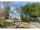 Charming backyard featuring a white house, stone patio, and lush landscaping at 234 N Race St, Statesville, NC 28677