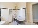 Bathroom featuring a clawfoot tub, classic fixtures, and timeless black and white tile flooring at 234 N Race St, Statesville, NC 28677