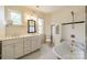 Bright bathroom with double vanity sinks, storage cabinet and vintage-inspired fixtures at 234 N Race St, Statesville, NC 28677