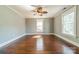 Spacious bedroom with hardwood floors, a ceiling fan, and ample natural light from large windows at 234 N Race St, Statesville, NC 28677