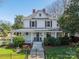 Charming two-story home featuring a welcoming front porch, mature landscaping, and classic architectural details at 234 N Race St, Statesville, NC 28677