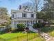 Attractive two-story home boasting a charming front porch, manicured landscaping, and a secure, fenced yard at 234 N Race St, Statesville, NC 28677