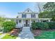 Beautiful two-story home showcasing a covered front porch, classic white exterior, and well-manicured landscaping at 234 N Race St, Statesville, NC 28677