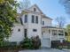 Side view of a beautiful home featuring a covered porch, manicured landscaping, and classic architectural style at 234 N Race St, Statesville, NC 28677