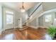 Elegant foyer with hardwood floors, staircase, and decorative lighting fixture at 234 N Race St, Statesville, NC 28677