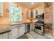 Charming kitchen with stainless steel appliances, contrasting countertops, and a bright window view at 234 N Race St, Statesville, NC 28677