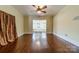 Inviting living room with refinished hardwood floors, ceiling fan and a view into the front room at 234 N Race St, Statesville, NC 28677