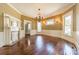 Light-filled living room with fireplace, chandelier, and gleaming hardwood floors at 234 N Race St, Statesville, NC 28677