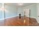 Cozy living room with hardwood floors and decorative fireplace, creating a warm and inviting atmosphere at 234 N Race St, Statesville, NC 28677