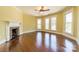 Spacious living room with a brick fireplace, hardwood floors and lots of natural light from multiple windows at 234 N Race St, Statesville, NC 28677