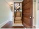 Wooden staircase featuring painted risers, hardwood floors, a wooden door, and traditional accents at 234 N Race St, Statesville, NC 28677