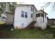 Backyard view of a two-story home featuring a screened-in porch and wooden stairs at 234 S Ervin Ave, Newton, NC 28658