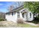 Charming two-story home with white siding, a covered entryway, and mature trees at 234 S Ervin Ave, Newton, NC 28658