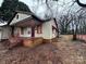 Modest home with a covered front porch and neglected yard at 2501 Booker Ave, Charlotte, NC 28216