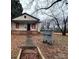 Exterior view of the home's neglected facade and overgrown yard at 2501 Booker Ave, Charlotte, NC 28216