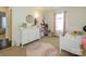 Bright bedroom with a neutral color scheme, white furniture, and natural light at 2518 Eargle Rd, Charlotte, NC 28269