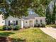 Charming single-story home with a well-manicured front yard and mature trees at 2518 Eargle Rd, Charlotte, NC 28269