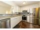 Well-lit kitchen featuring stainless steel appliances, granite countertops, and gray tile backsplash at 2518 Eargle Rd, Charlotte, NC 28269