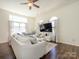 Inviting living room featuring bright windows, plush seating, and seamless flow to dining area at 2518 Eargle Rd, Charlotte, NC 28269