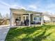 Covered patio with a dining set, grill, outdoor seating, and a view of the well-maintained backyard at 2518 Eargle Rd, Charlotte, NC 28269