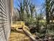 The backyard features a deck, newly laid straw, and views of the surrounding woods at 347 Sidney St, Rock Hill, SC 29730