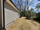 Newly seeded backyard with gray vinyl siding and stacked stone foundation at 347 Sidney St, Rock Hill, SC 29730