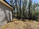 The backyard features newly laid straw, level ground and views of the surrounding woods at 347 Sidney St, Rock Hill, SC 29730