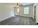 Bright bedroom featuring gray flooring, modern ceiling fan, white trim, and a door to the exterior at 347 Sidney St, Rock Hill, SC 29730