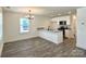 Modern kitchen featuring gray floors, stainless steel appliances, granite countertops, and a center island at 347 Sidney St, Rock Hill, SC 29730