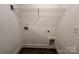 Functional laundry room with wire shelving, utility connections, and modern flooring at 347 Sidney St, Rock Hill, SC 29730