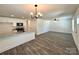 Open-concept living space with kitchen, dining, and living room featuring modern vinyl wood floors at 347 Sidney St, Rock Hill, SC 29730