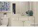 This is a bathroom with white cabinets, a mirror, and decorative vases, accented by a modern art piece at 4187 Skyboat Cir, Fort Mill, SC 29715