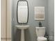 Cozy half bathroom featuring a pedestal sink, toilet, framed artwork, and neutral wall color at 4187 Skyboat Cir, Fort Mill, SC 29715