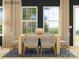 Inviting dining room with natural wood table, stylish woven chairs, jute rug, and large windows at 4187 Skyboat Cir, Fort Mill, SC 29715