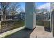 This backyard features a tall brick fence, a small storage space, and is paved with a concrete patio at 419 W 8Th St, Charlotte, NC 28202