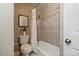 Cozy bathroom with tiled walls, a combined bathtub and shower, and decorative accents at 419 W 8Th St, Charlotte, NC 28202