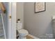 Cozy bathroom with white toilet, neutral walls, and a decorative accent art piece at 419 W 8Th St, Charlotte, NC 28202