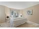 Inviting bedroom with plush white bedding, accent pillows, and bright natural light from a window at 419 W 8Th St, Charlotte, NC 28202