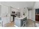 Modern kitchen featuring white cabinets, stainless steel appliances, and a stylish gray island with seating at 419 W 8Th St, Charlotte, NC 28202