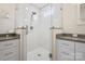 Contemporary bathroom featuring a glass shower with white marble tiling and dual vanities at 4329 Castleton Rd, Charlotte, NC 28211