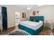 Comfortable bedroom featuring a teal bed frame, white linens, and hardwood floors at 4329 Castleton Rd, Charlotte, NC 28211