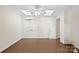 This bedroom features neutral walls, a tray ceiling with fan, and hardwood floors at 4329 Castleton Rd, Charlotte, NC 28211