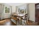 Bright dining area with hardwood floors, large windows, and a wooden table at 4329 Castleton Rd, Charlotte, NC 28211