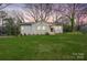 Charming white brick home with manicured lawn and lovely landscaping at twilight at 4329 Castleton Rd, Charlotte, NC 28211