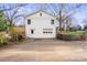 Two story garage with a two car garage door, a pedestrian door, and a window on the second floor at 4329 Castleton Rd, Charlotte, NC 28211