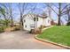 Two story garage with a two car garage door, a pedestrian door, and a stone stairway at 4329 Castleton Rd, Charlotte, NC 28211