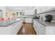 Modern kitchen featuring stainless steel appliances, an island, and a marble backsplash at 4329 Castleton Rd, Charlotte, NC 28211