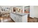 Open kitchen featuring an island with seating and stainless steel appliances at 4329 Castleton Rd, Charlotte, NC 28211