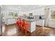 Stylish kitchen with a center island, white cabinetry, and stainless steel appliances at 4329 Castleton Rd, Charlotte, NC 28211