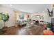 Inviting living room showcases hardwood floors, a modern sofa, and a decorative rug at 4329 Castleton Rd, Charlotte, NC 28211